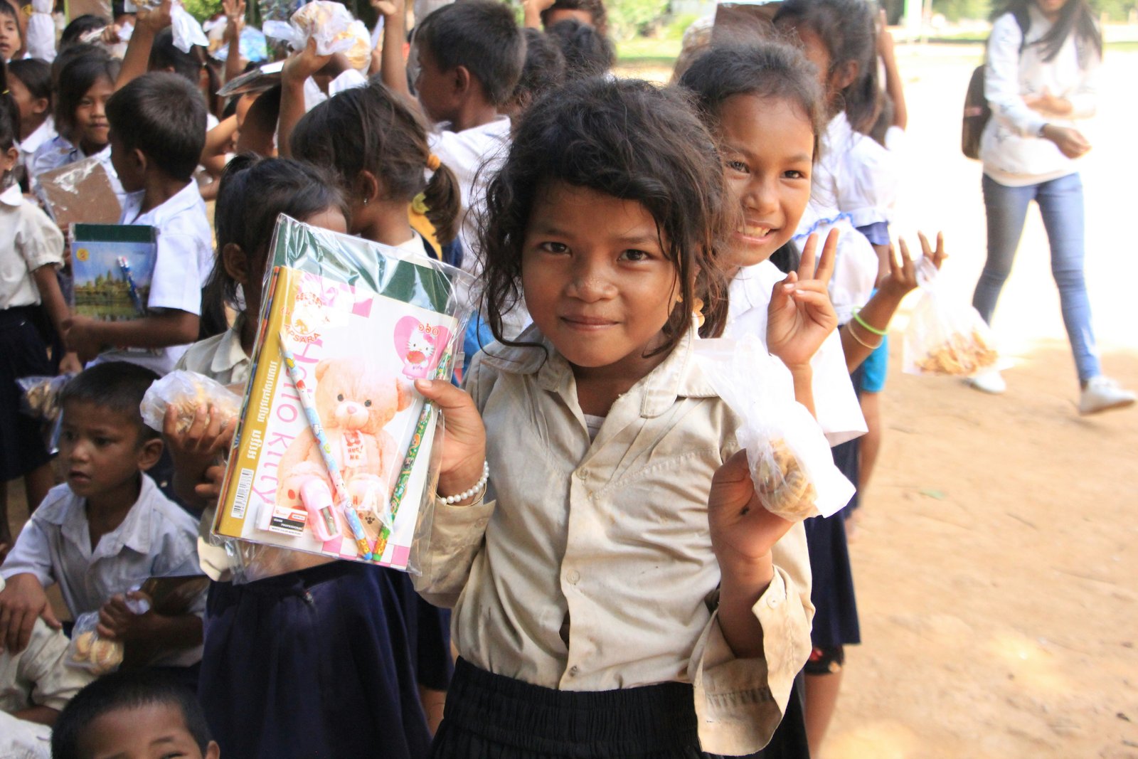 Children receiving gift hampers of books and toys